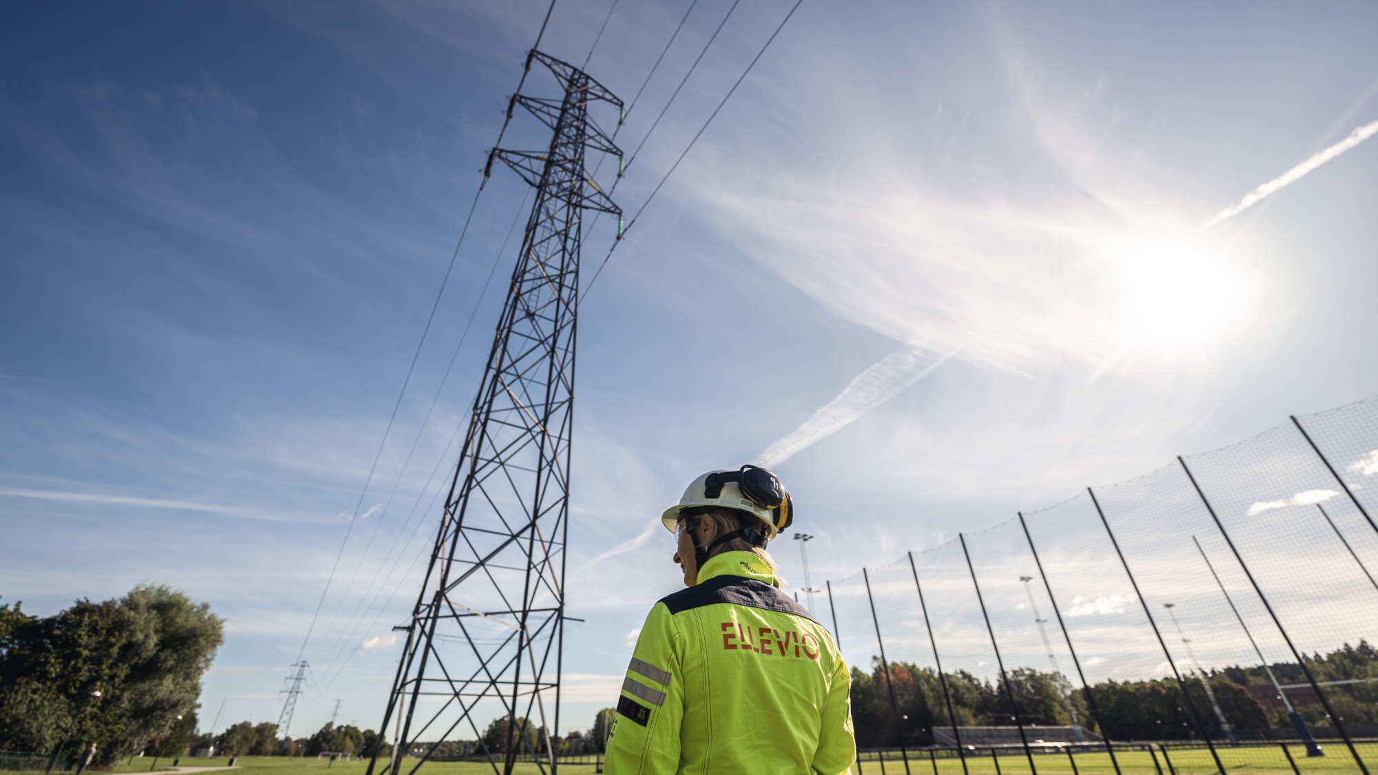 En man står framför en kraftledning.