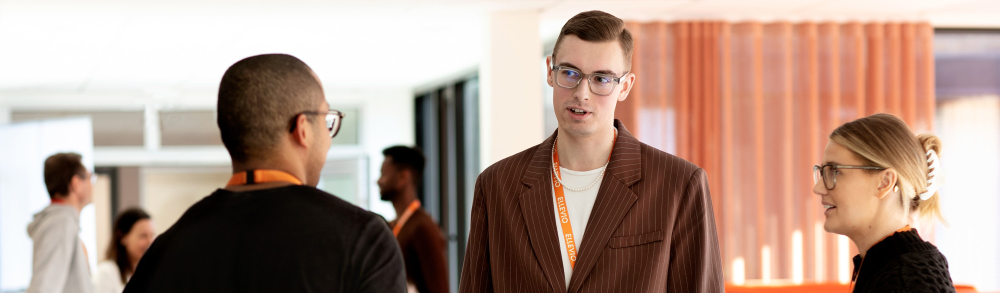 En man i kostym och glasögon står bredvid en kvinna.